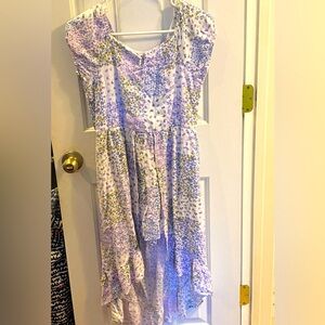 High-low girls purple floral dress with built in shorts. Girls size XL.